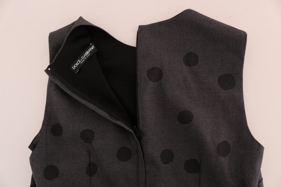 A gray polka dotted vest with a black zippered front