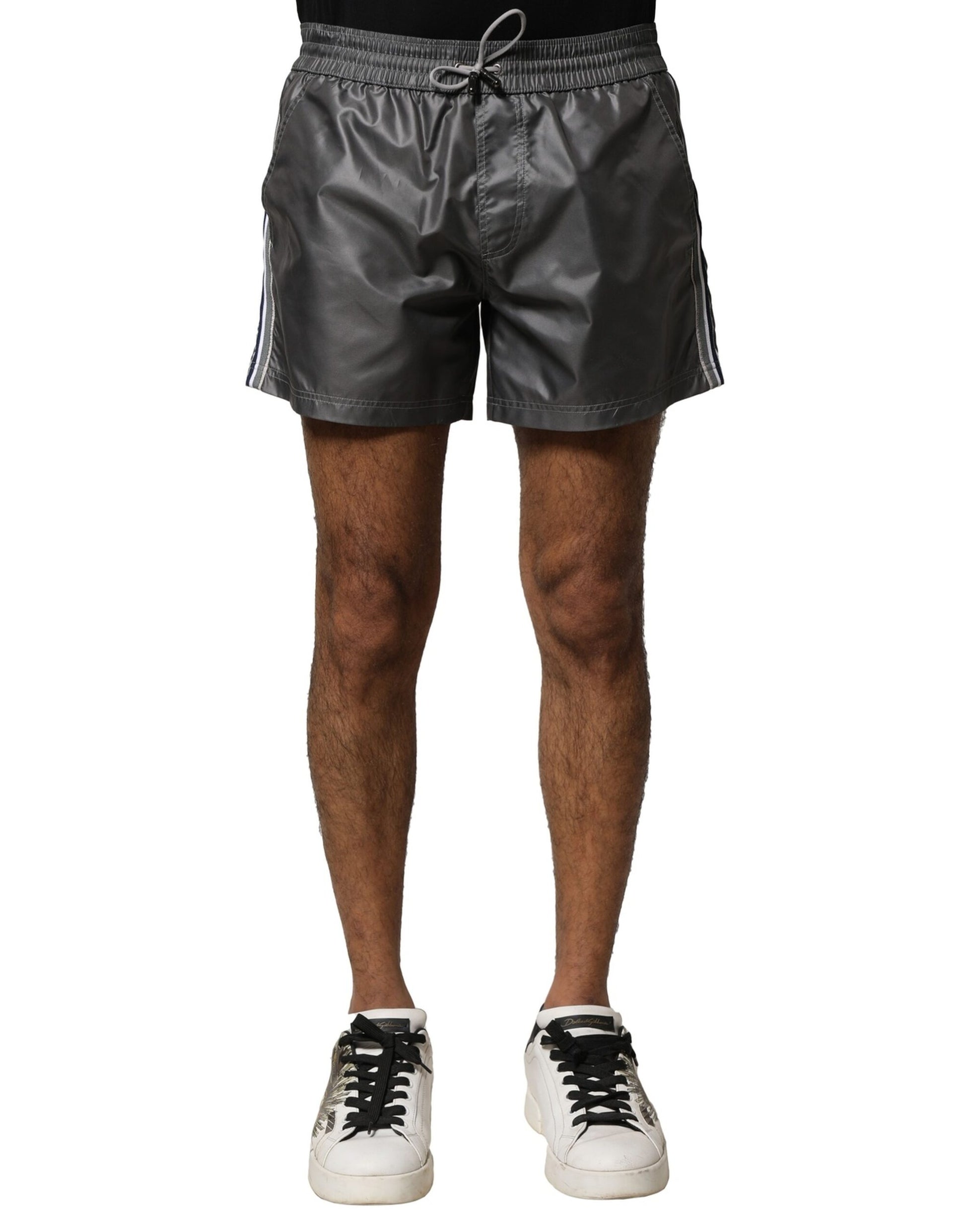 Man wearing black shorts and white sneakers