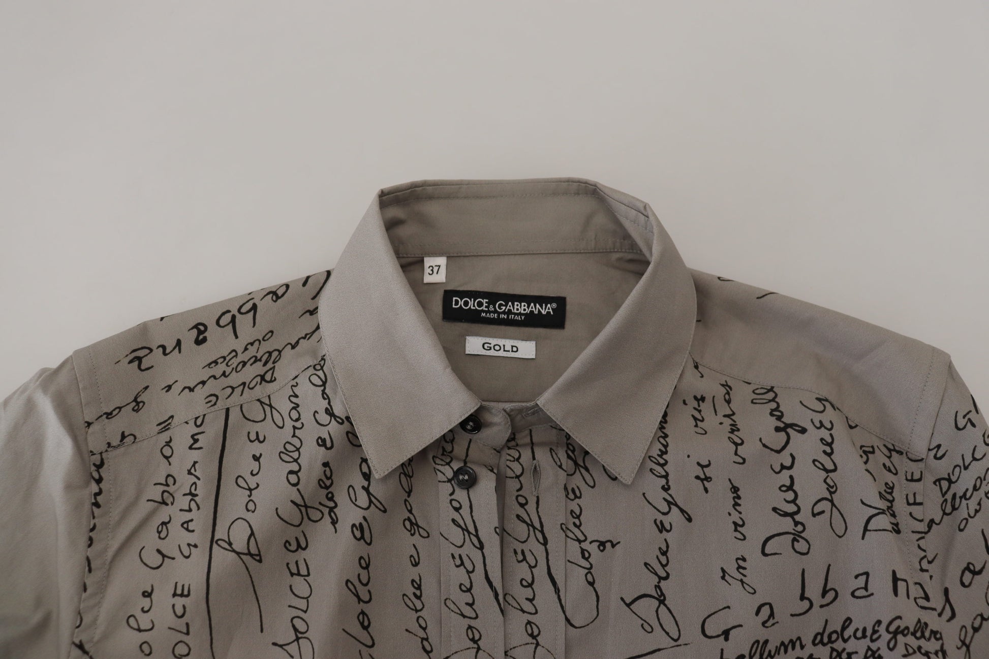 A gray printed cotton slim dress with a gold shirt, featuring handwritten text on the front