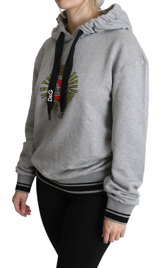 Woman wearing gray hoodie with graphic on front