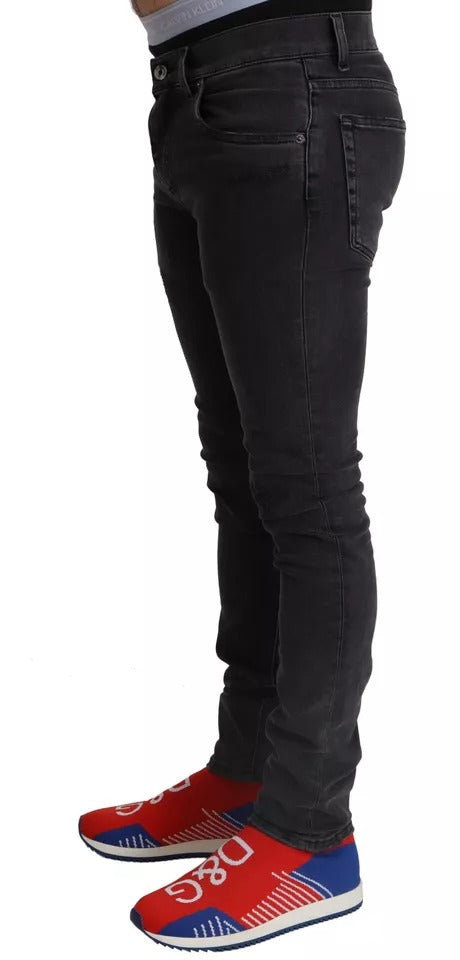Man wearing black pants and red shoes