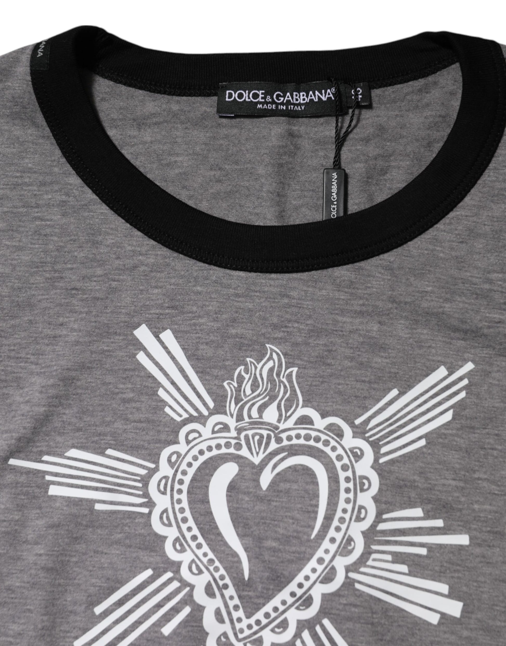 The shirt is gray with a heart design on the front