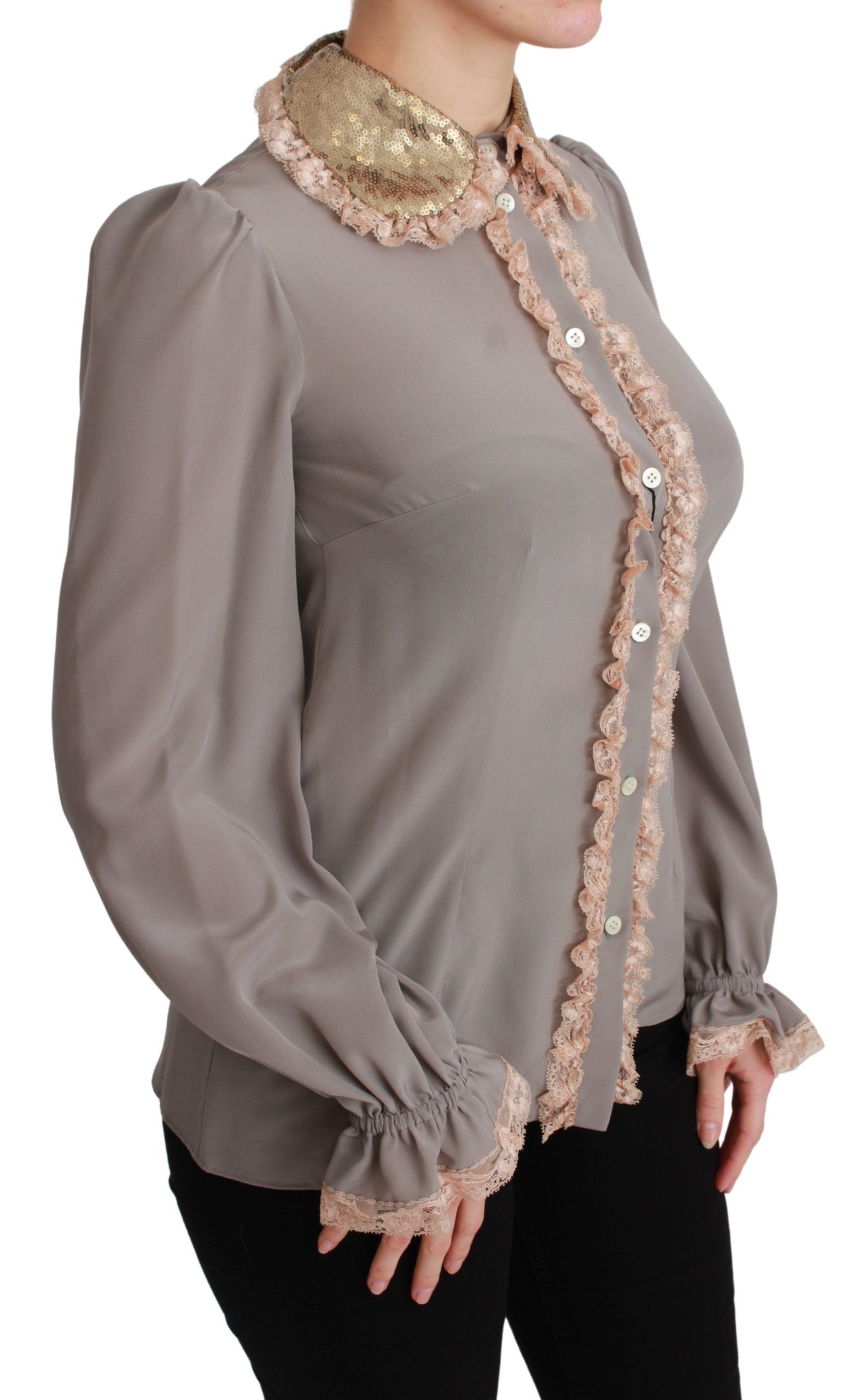 Woman wearing a long sleeve blouse with lace detailing on collar and cuffs