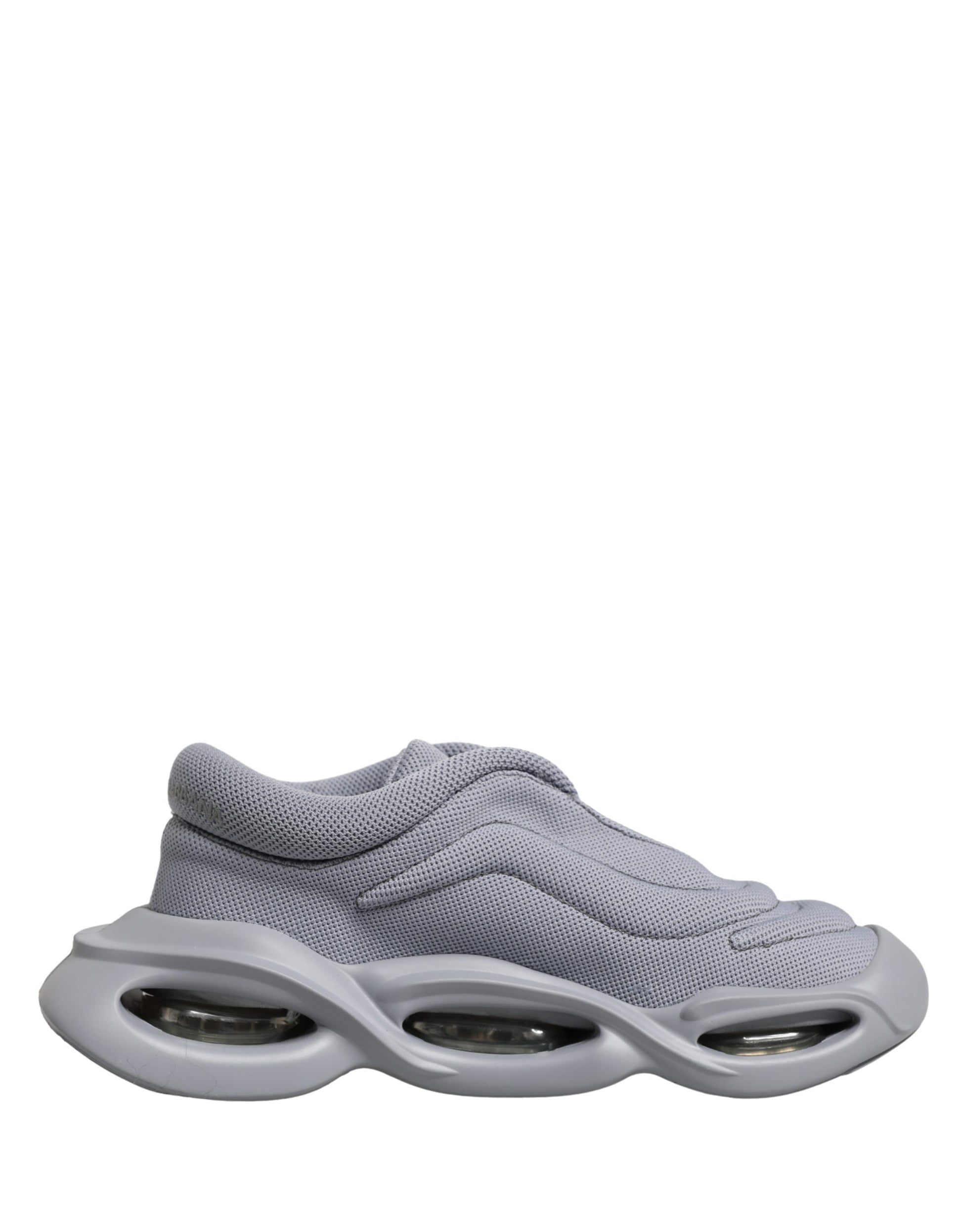 A pair of gray slip-on shoes with a wave design on the sole