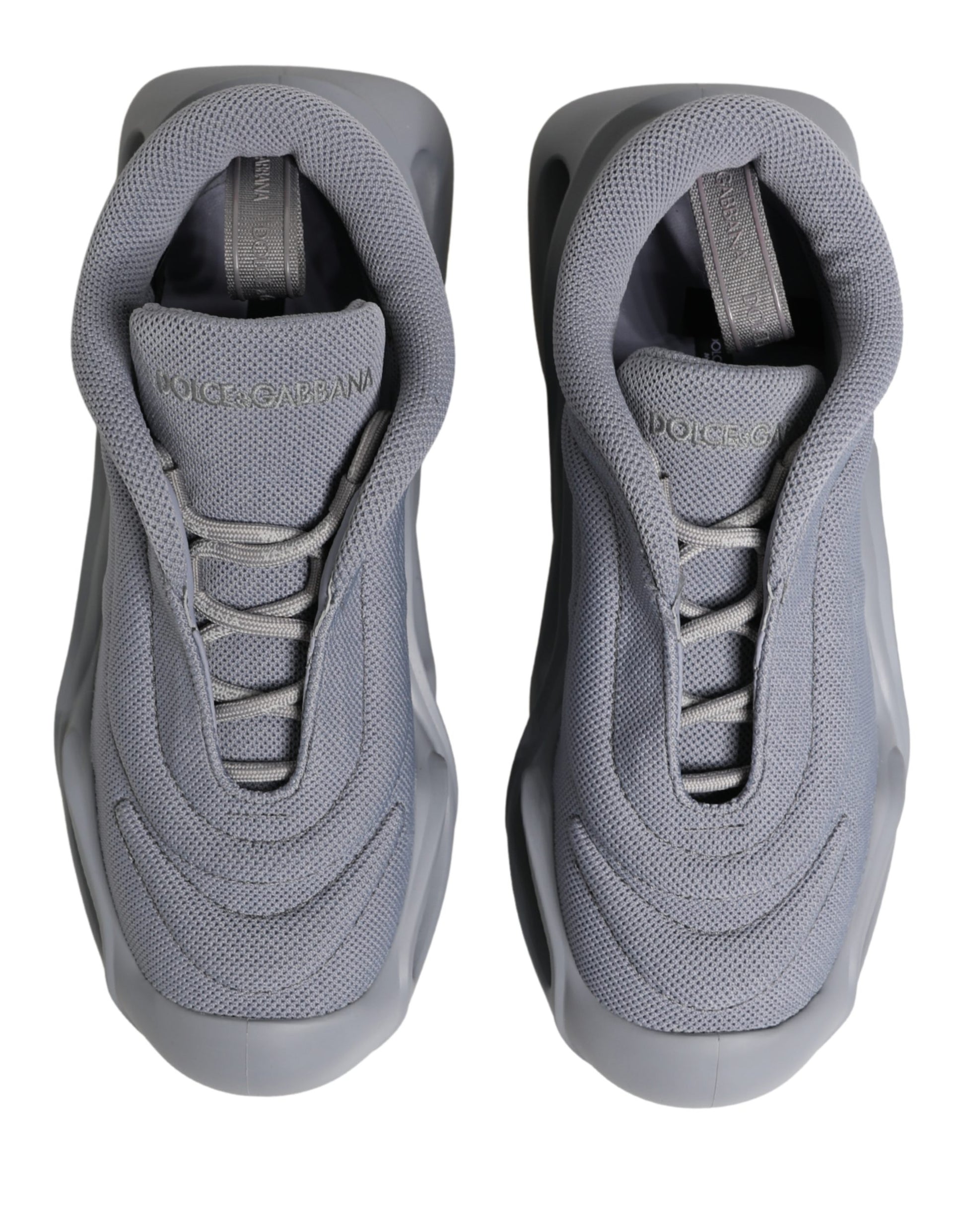 Pair of gray slip-on shoes with laces and brand logo on side