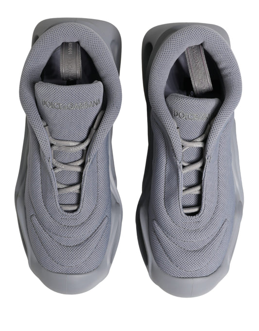 Pair of gray slip-on shoes with laces and brand logo on side