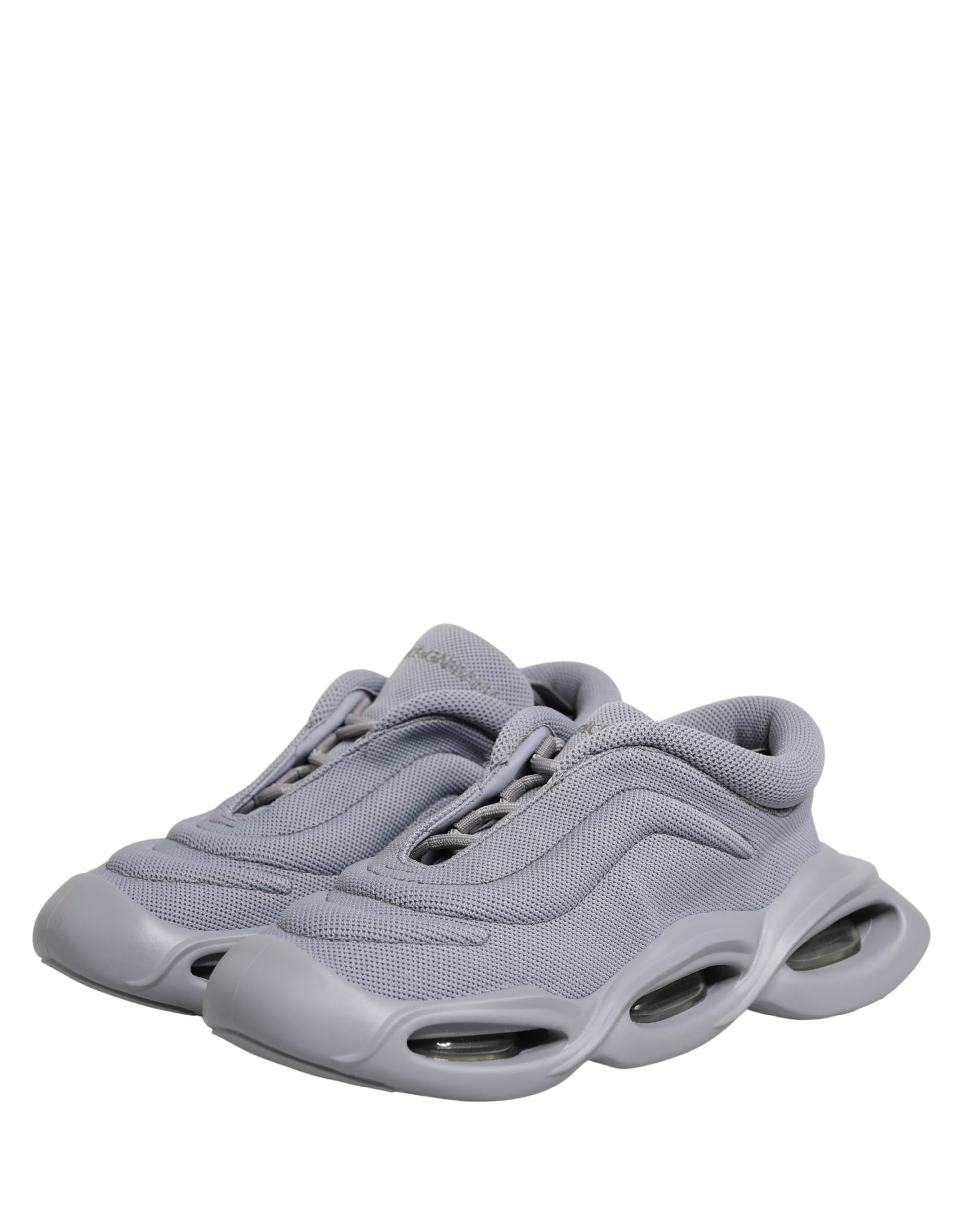 A pair of gray slip-on shoes with a wave design on the side, featuring a low top and a visible logo