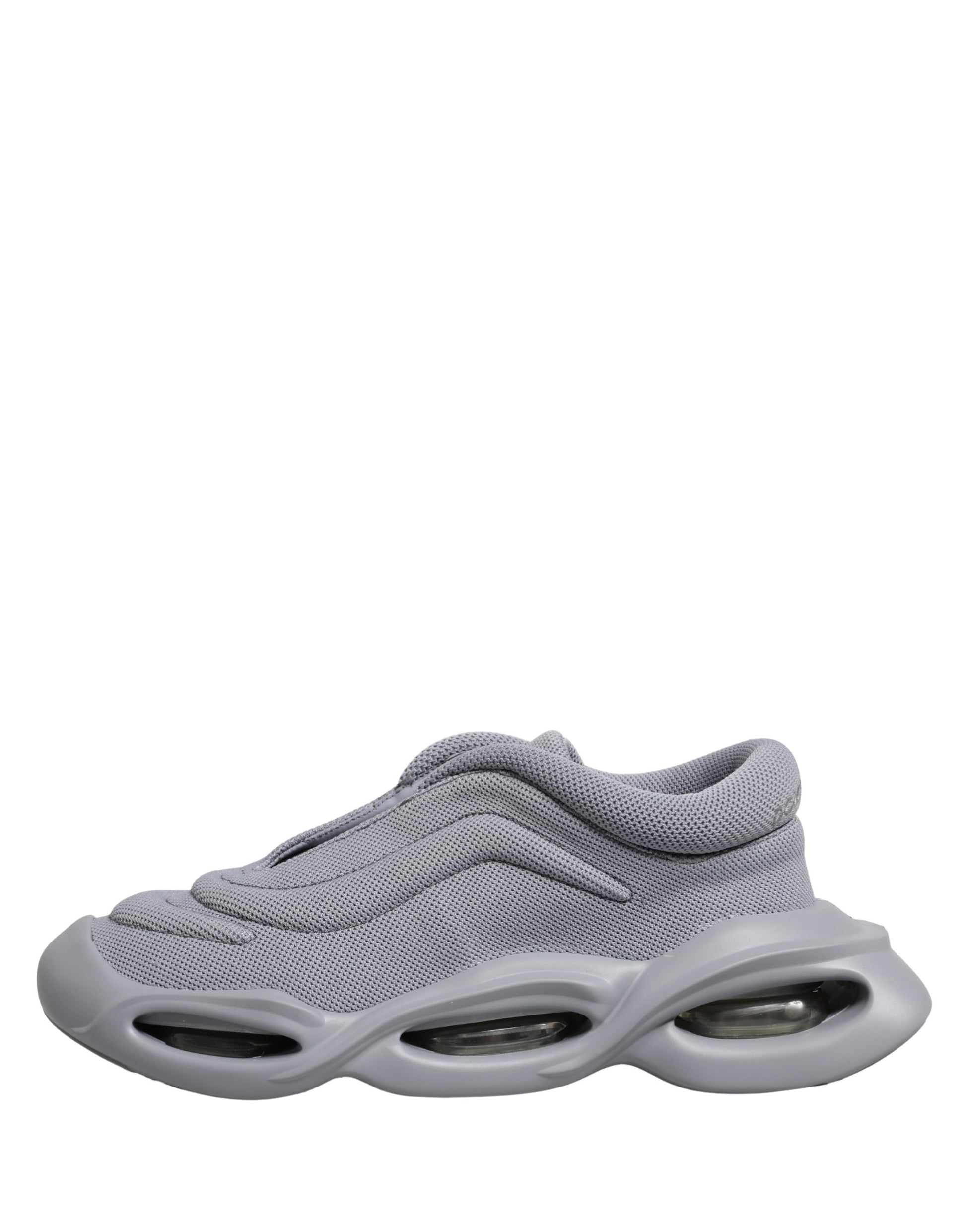 A pair of gray slip-on shoes with a wave design on the sole