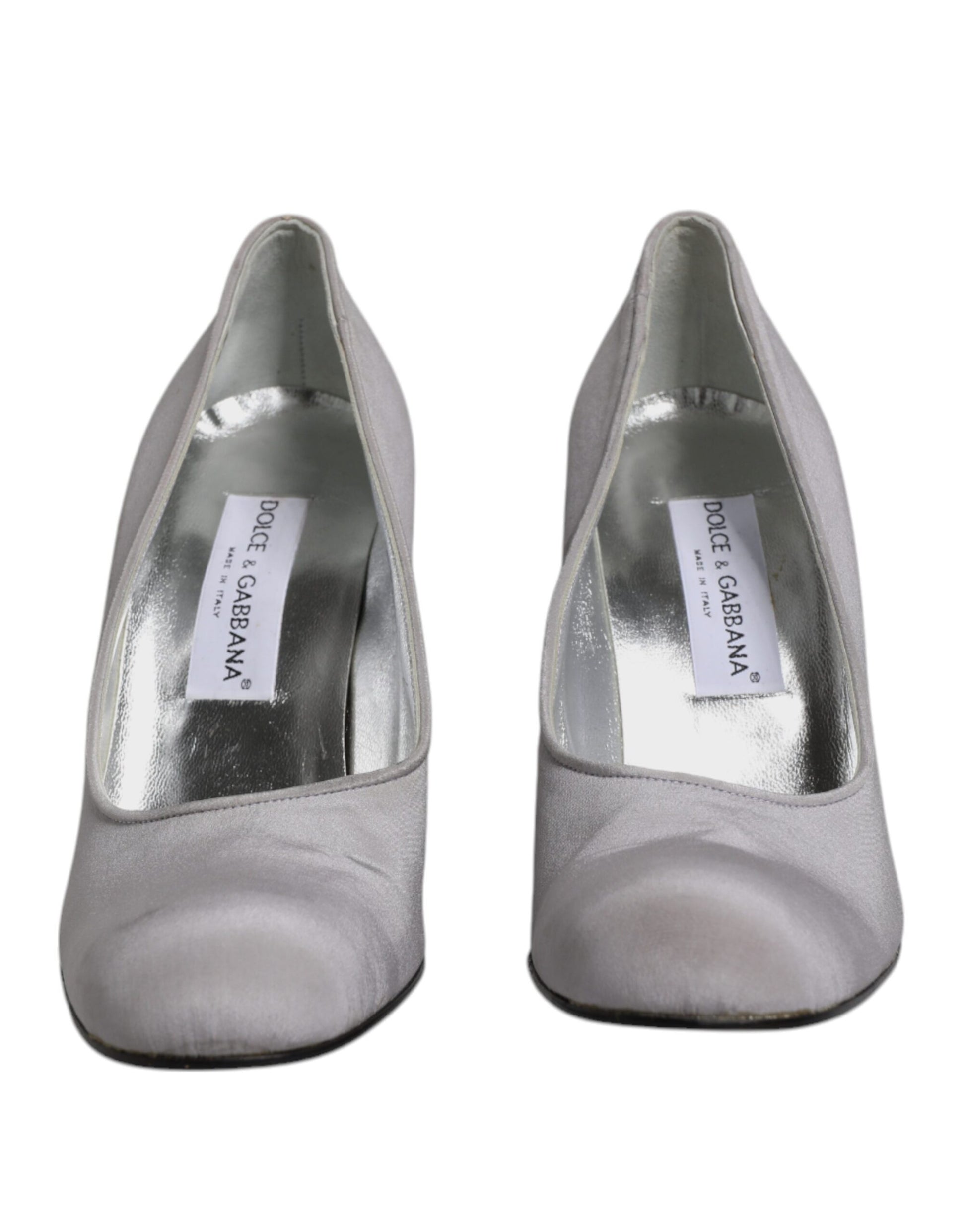 Silver high heel shoes with a label on the inside