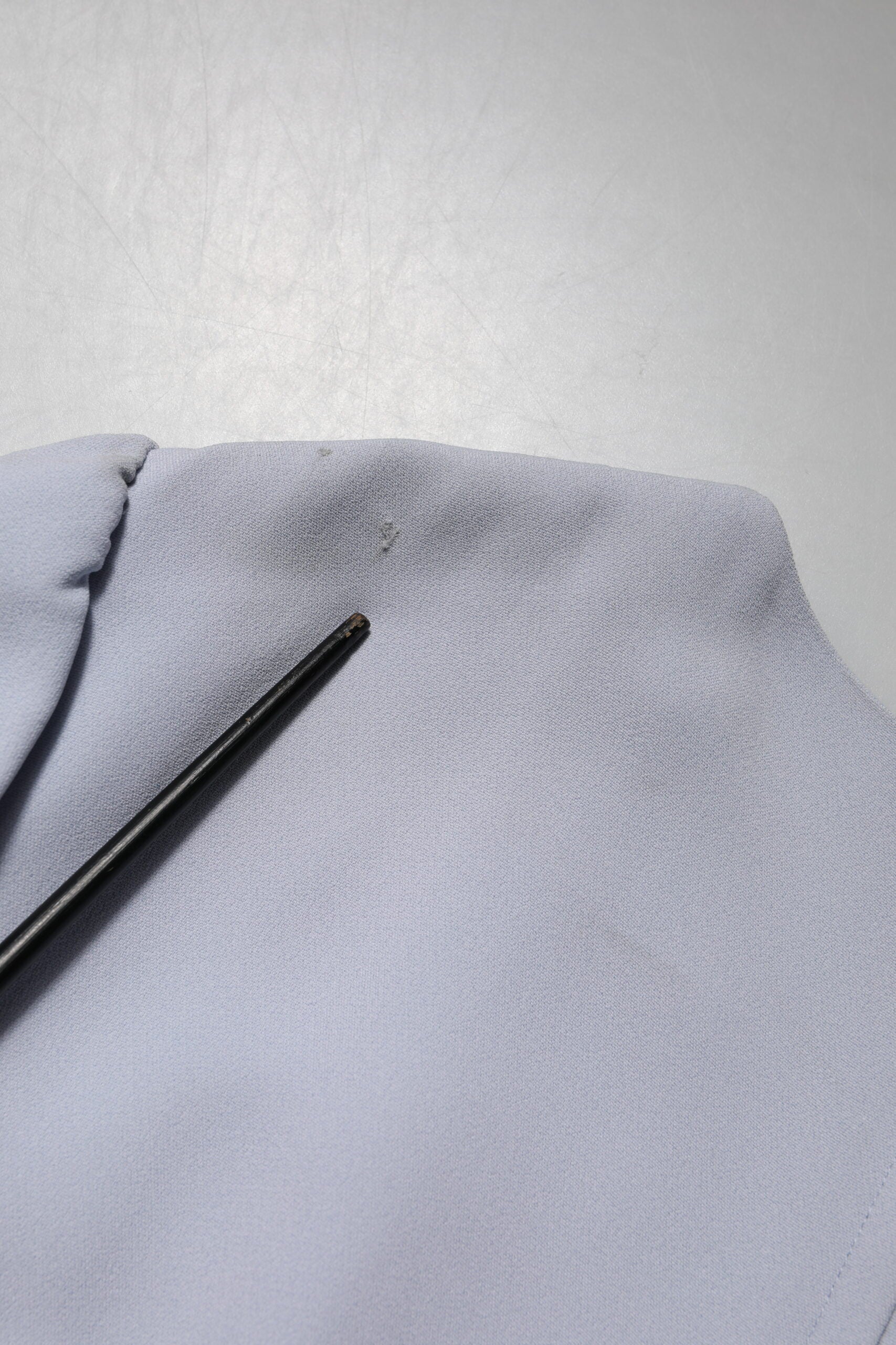Blue fabric with black pen on top