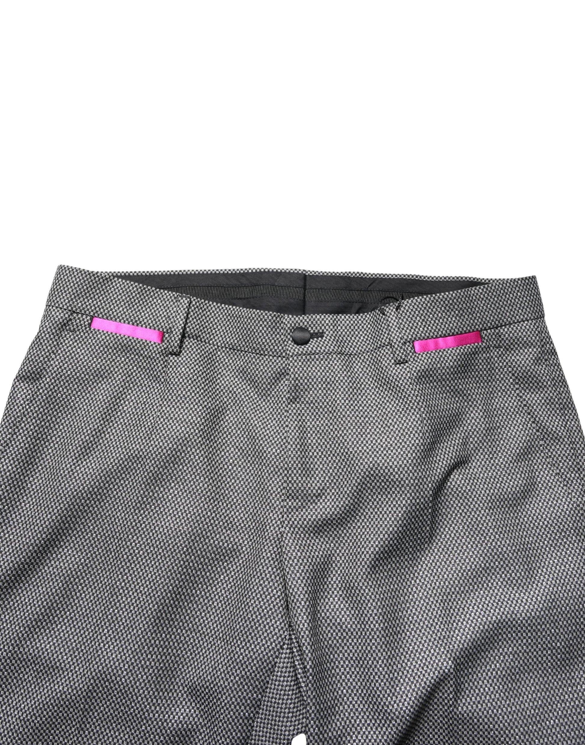 A pair of gray viscose skinny men's dress trousers with a pink accent on the waistband