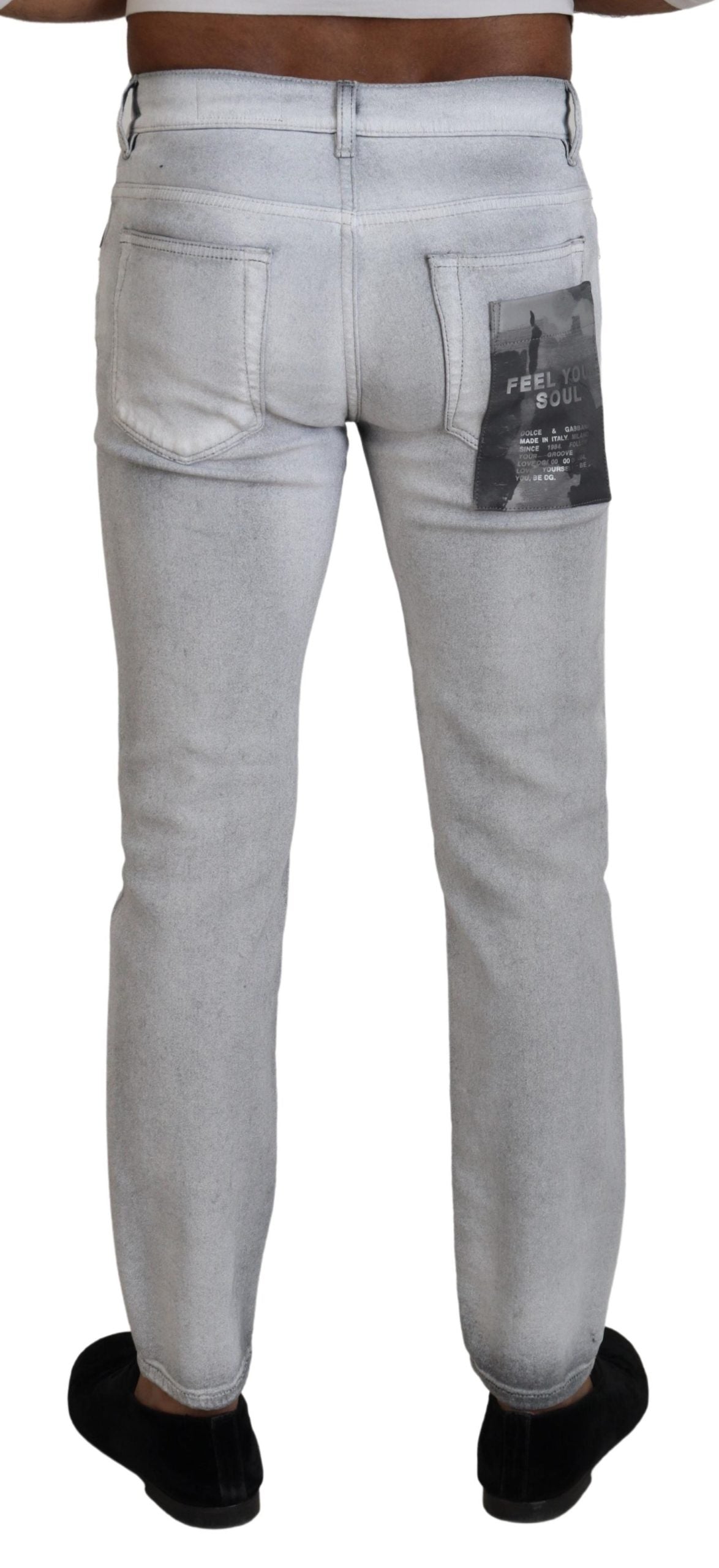 Pair of light blue denim jeans with distressed areas on legs