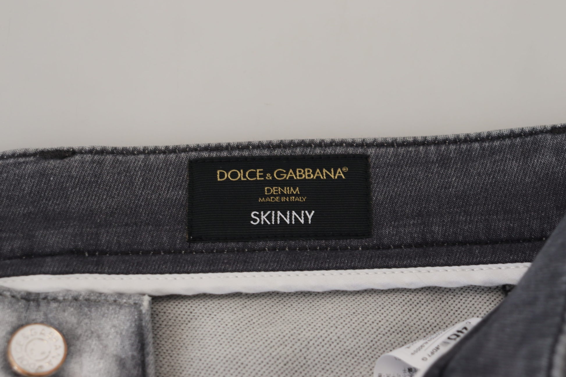 A pair of jeans with a label that reads "Dolce & Gabbana SINNY"