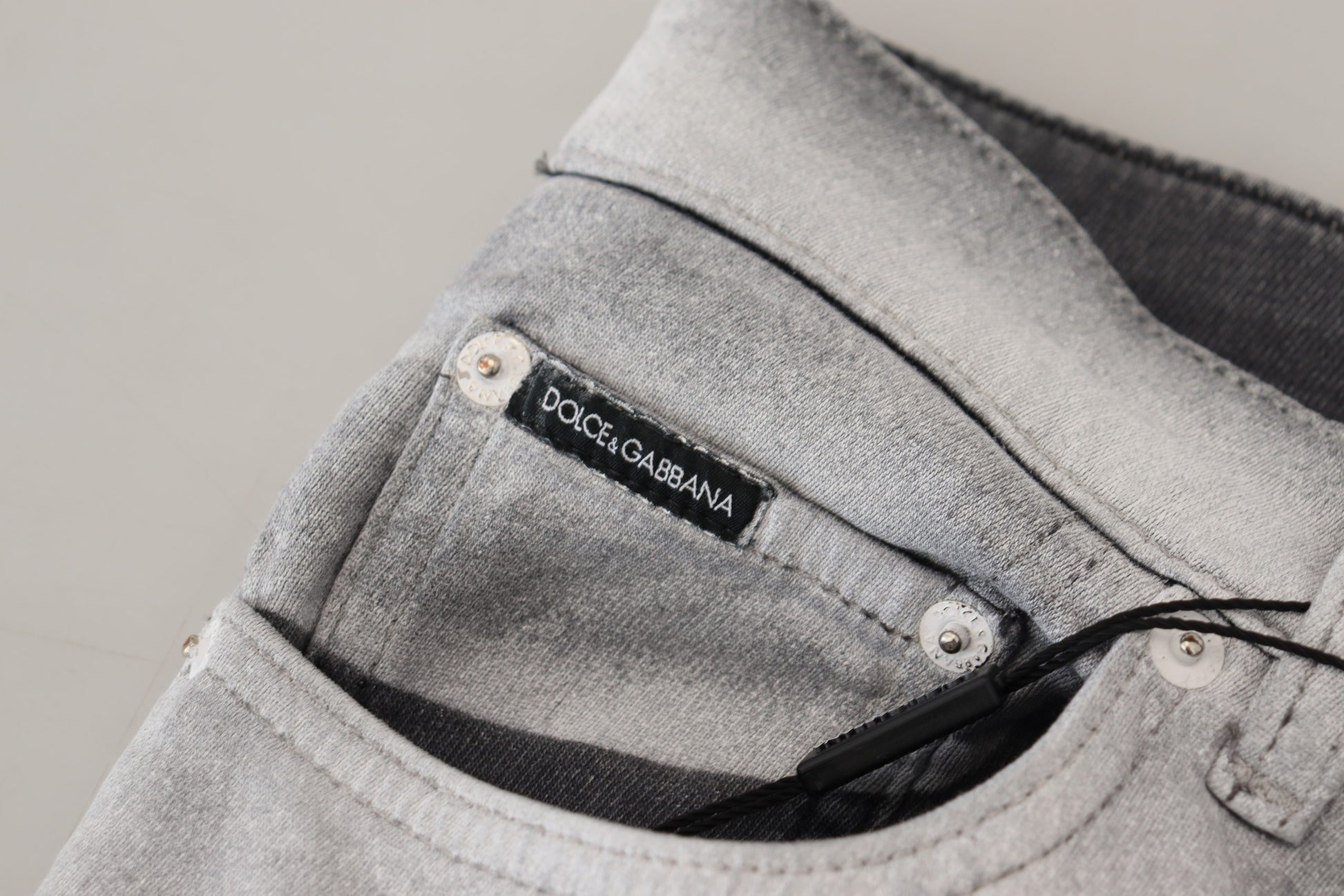 Grey denim jeans with visible brand label on waistband