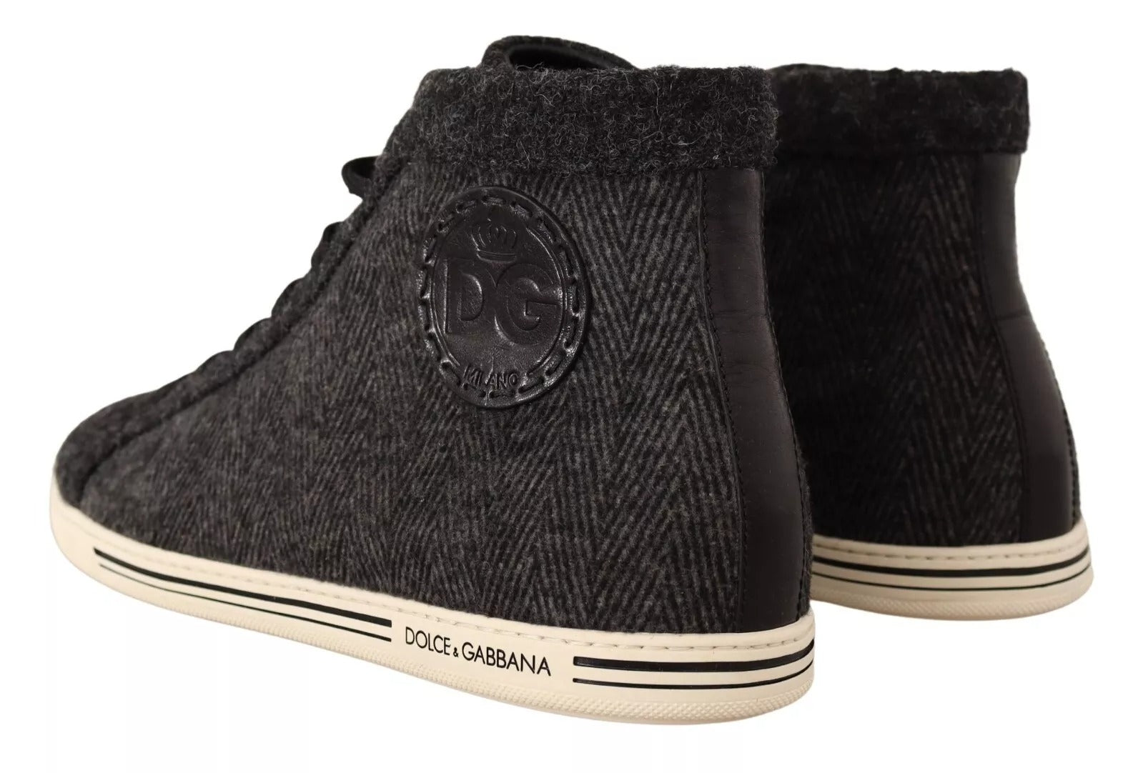 Pair of black suede boots with white laces and logo on side