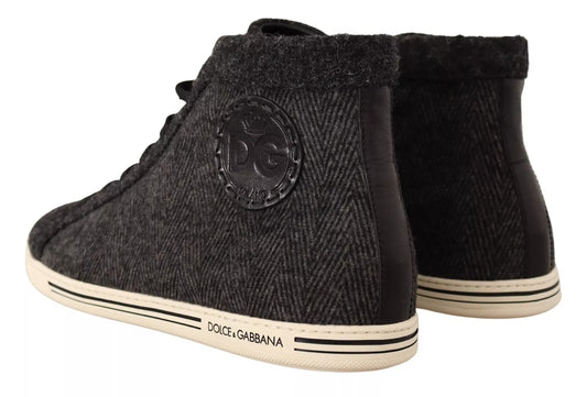 Pair of black suede boots with white laces and logo on side
