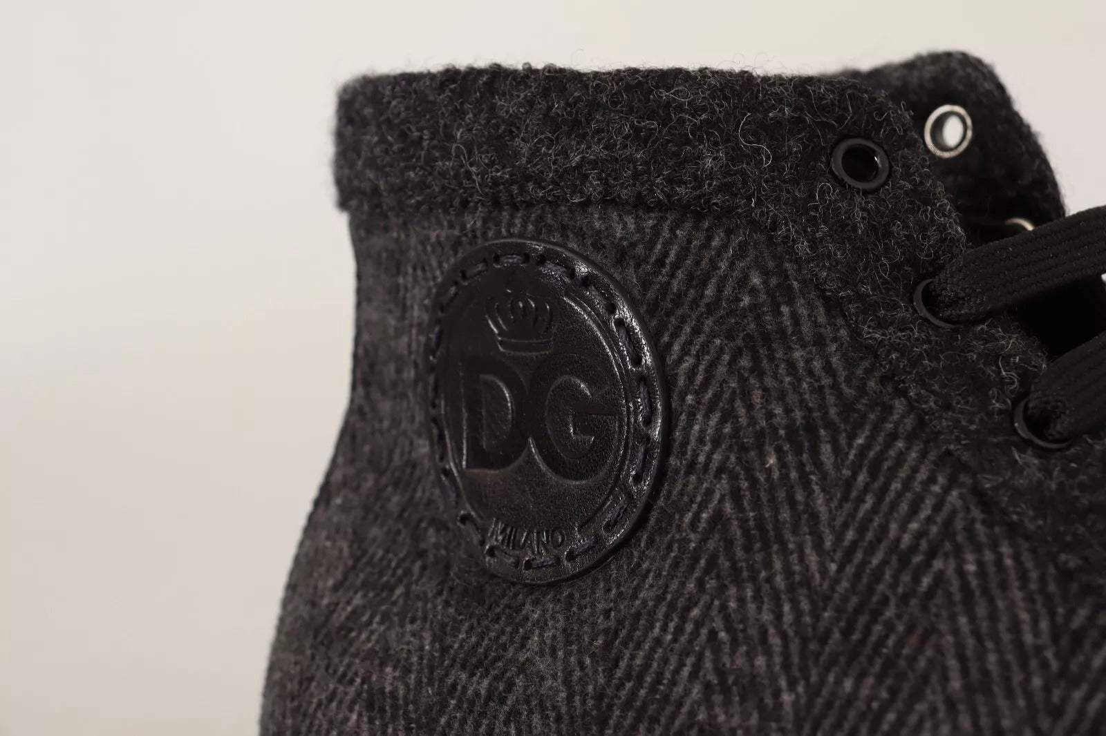 Black sneaker with white logo on side