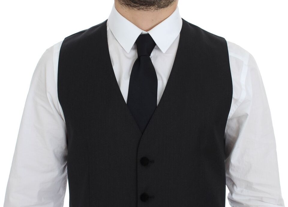 A gray wool vest with black buttons and a tie, part of a formal dress ensemble