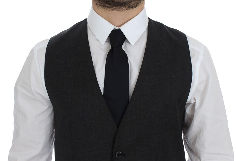 A gray wool vest, part of formal wear from the brand Dolce & Gabbana. It is designed as a gilet or weste and