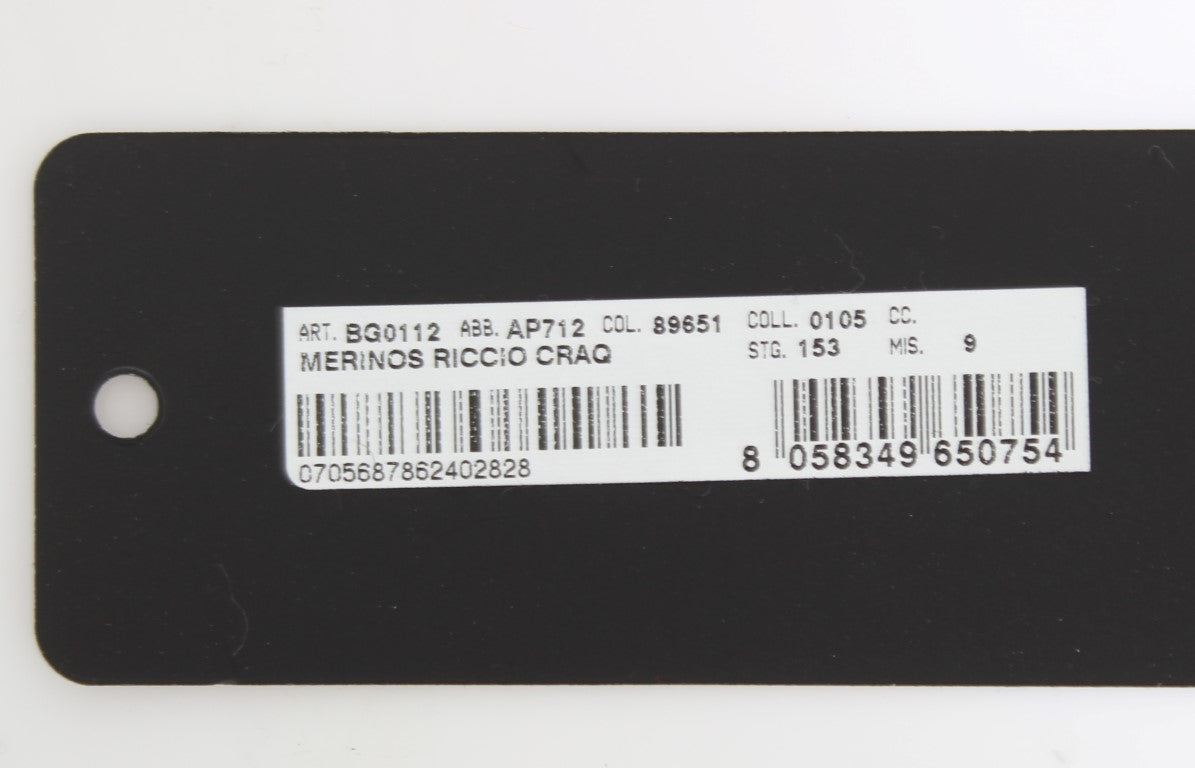 Black label on white surface with barcode and serial number