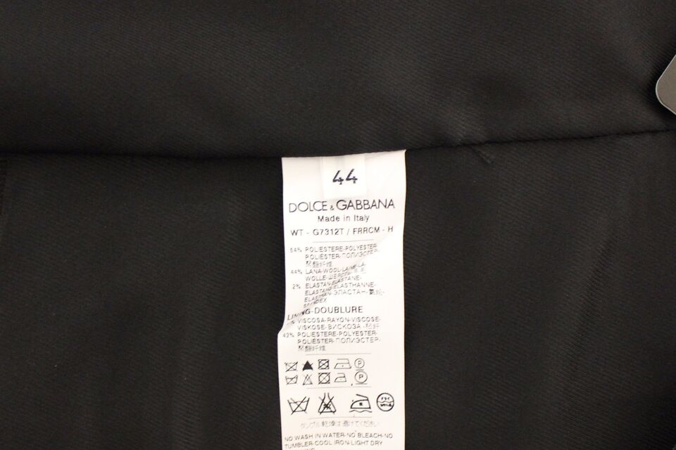A gray wool vest from Dolce & Gabbana, with a label indicating it's made of stretch material