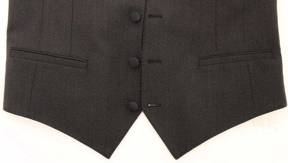 A gray wool vest blazer with black buttons and a stretchy fabric, part of a suit