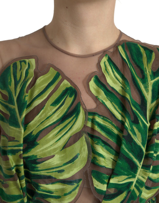 A sleeveless long maxi dress with a green banana leaf pattern