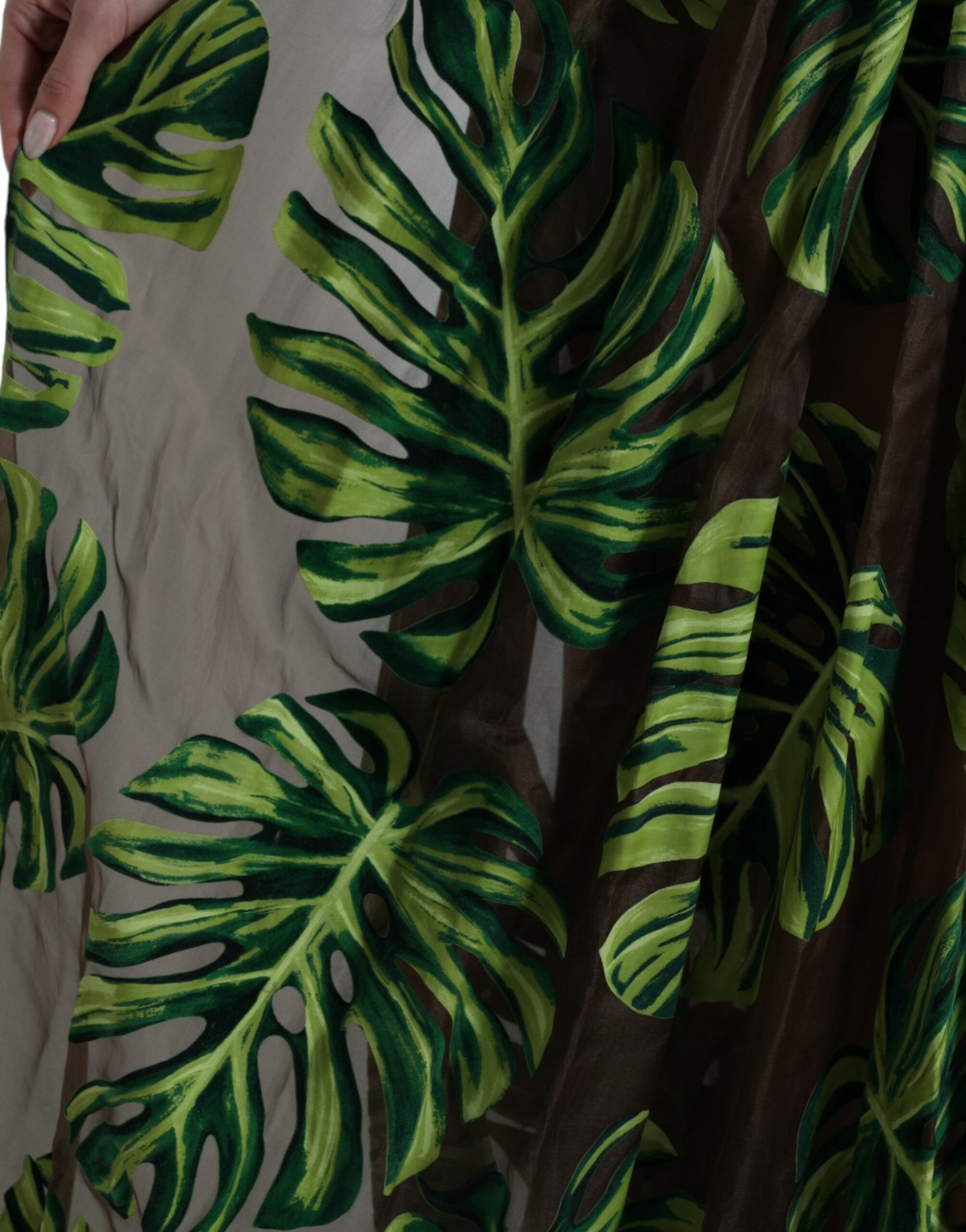 A sleeveless long maxi dress with a green banana leaf pattern