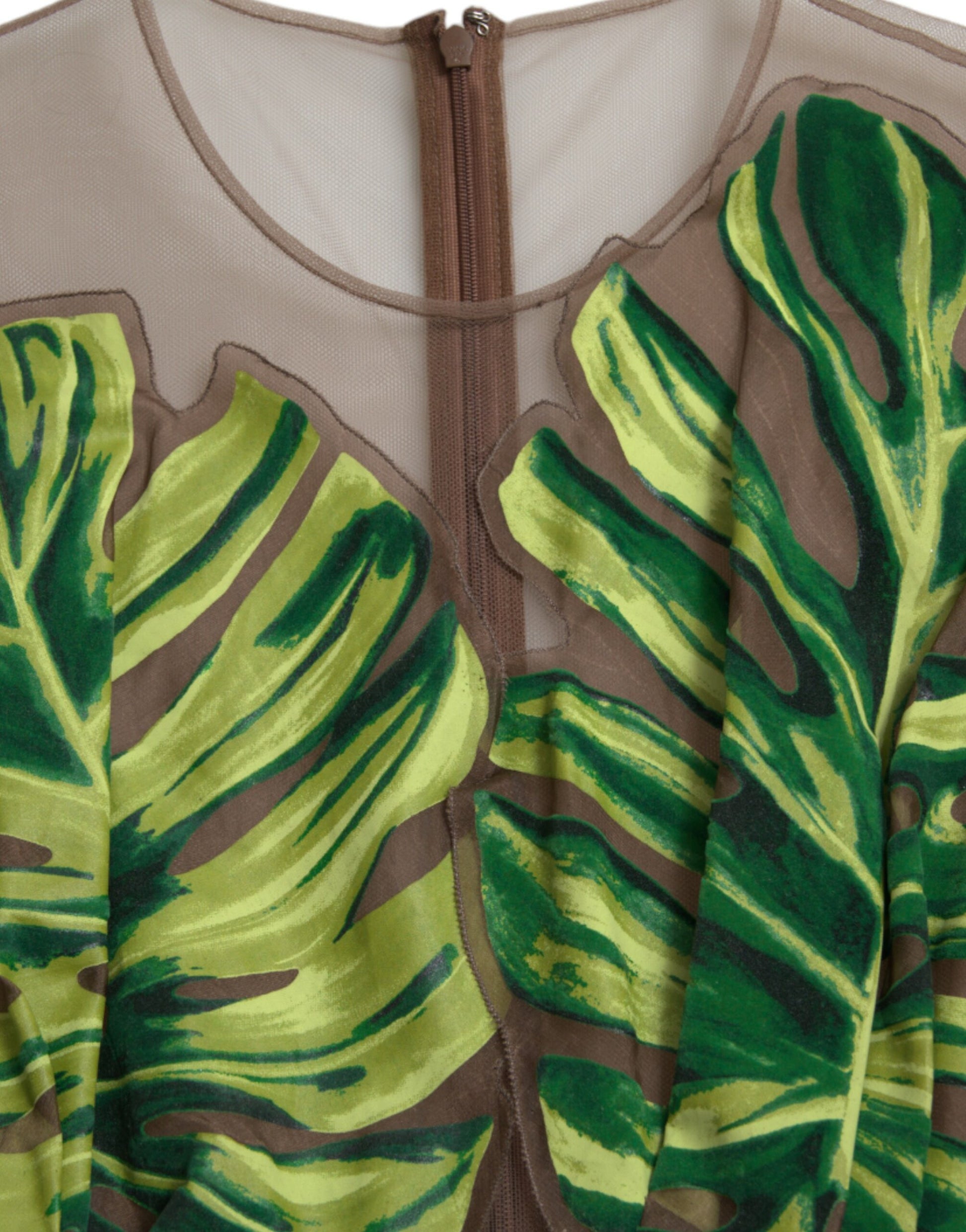 A sleeveless long maxi dress with a green and brown banana leaf print