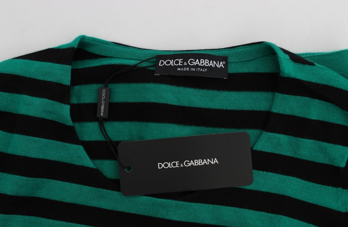 Green and black striped sweater on a white surface