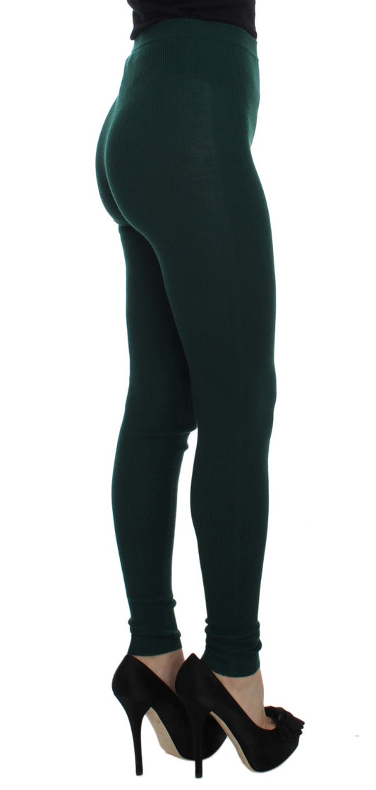 Pair of black high heels worn by a person wearing green leggings