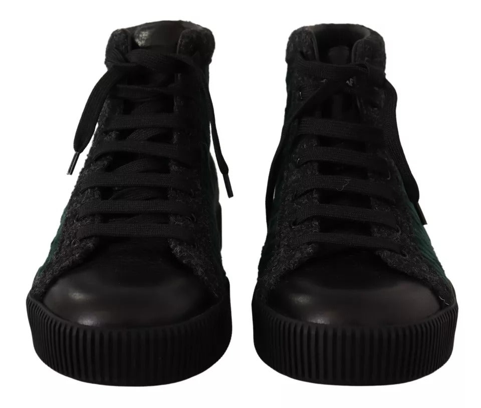 Pair of black high top sneakers with white laces and a rubber sole