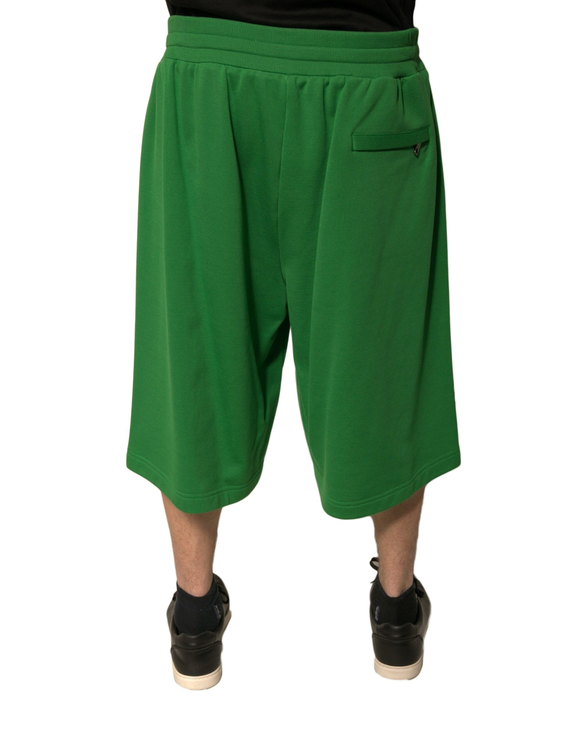 A pair of green cotton blend men's bermuda shorts with a pocket on the right leg