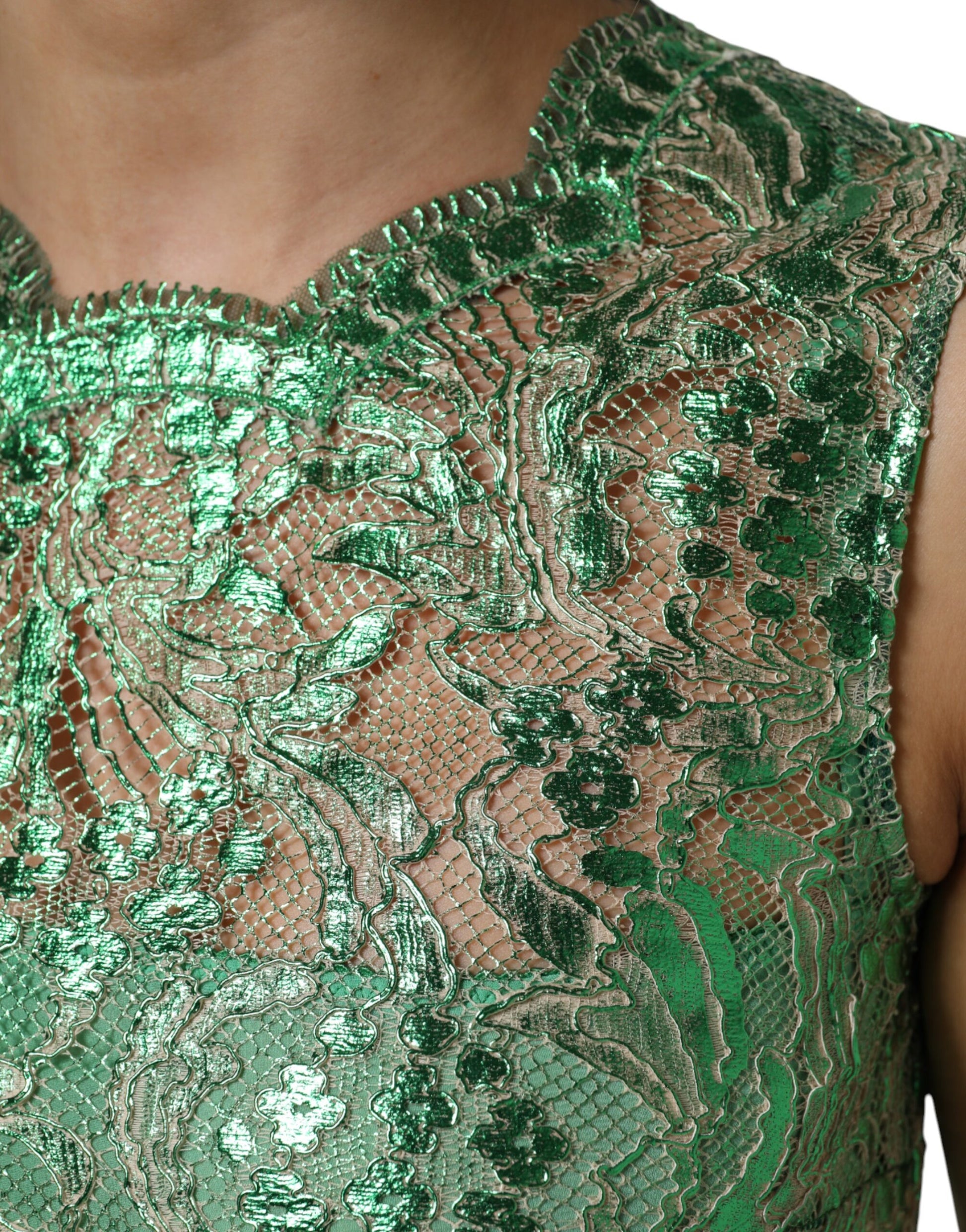 A green lace sheath dress with floral patterns