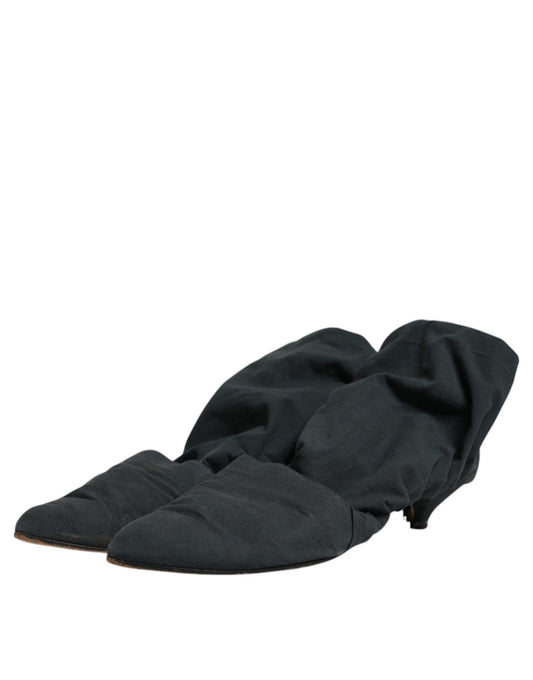 Pair of black socks lying flat on a surface