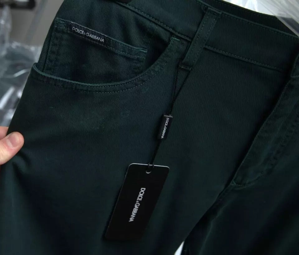 Pair of dark green jeans on a hanger