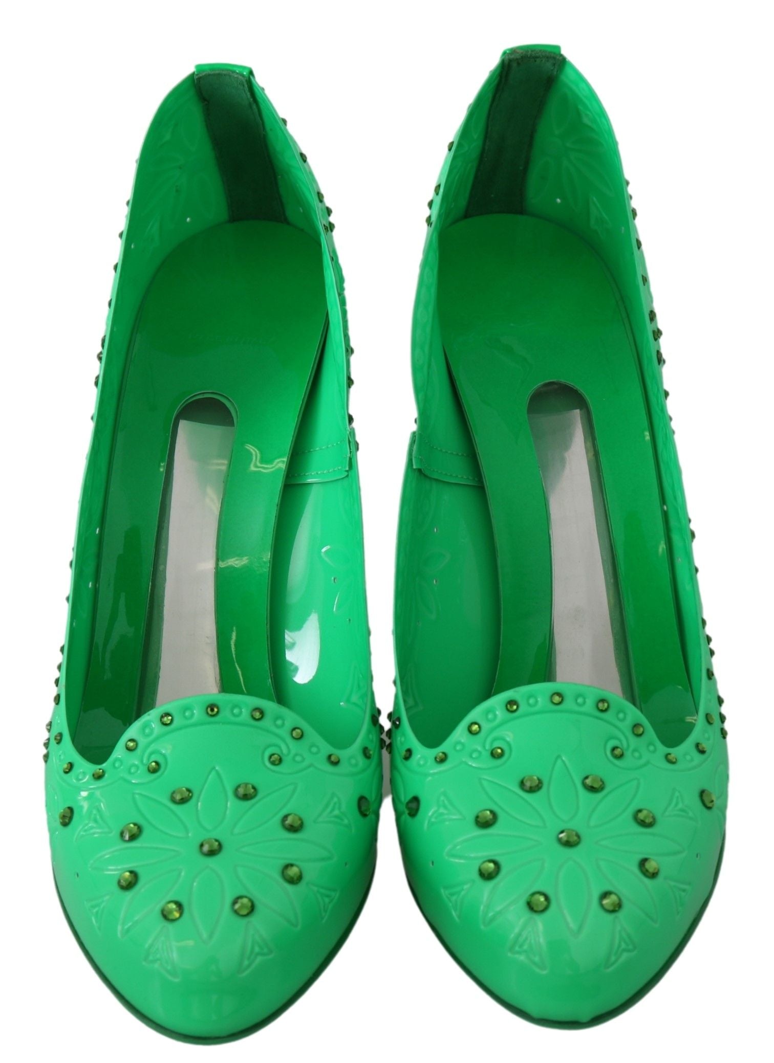 Pair of green shoes with studs and a bow on top