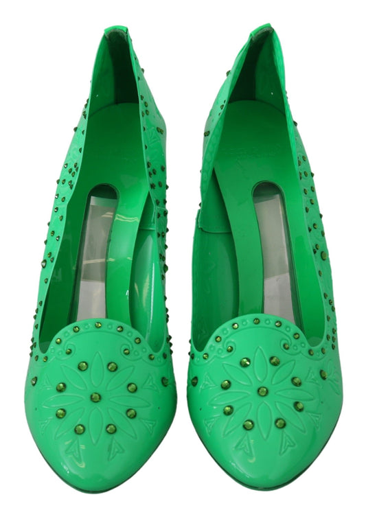 Pair of green high heel shoes with embellishments and straps