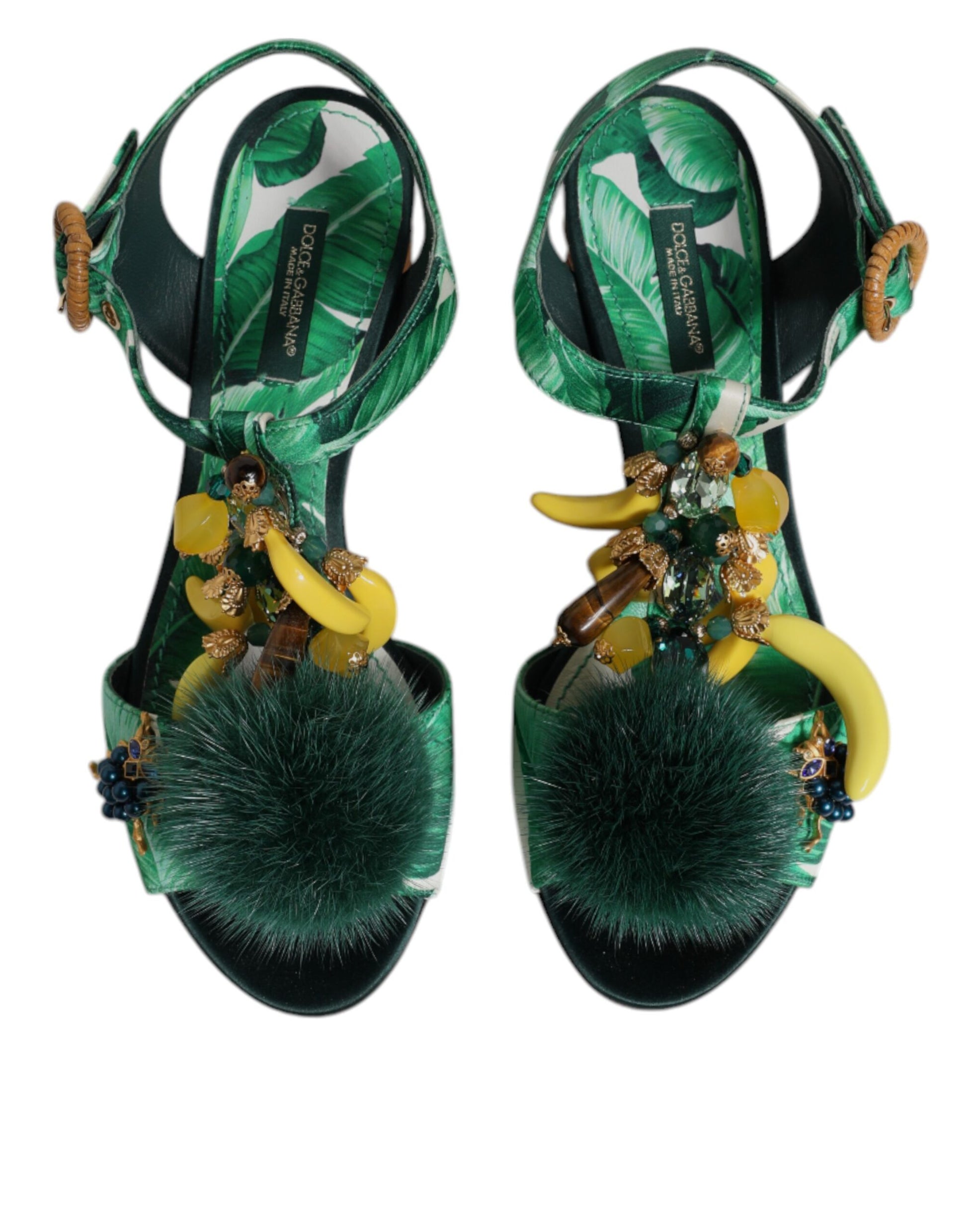 Pair of green sandals with banana and feather decorations