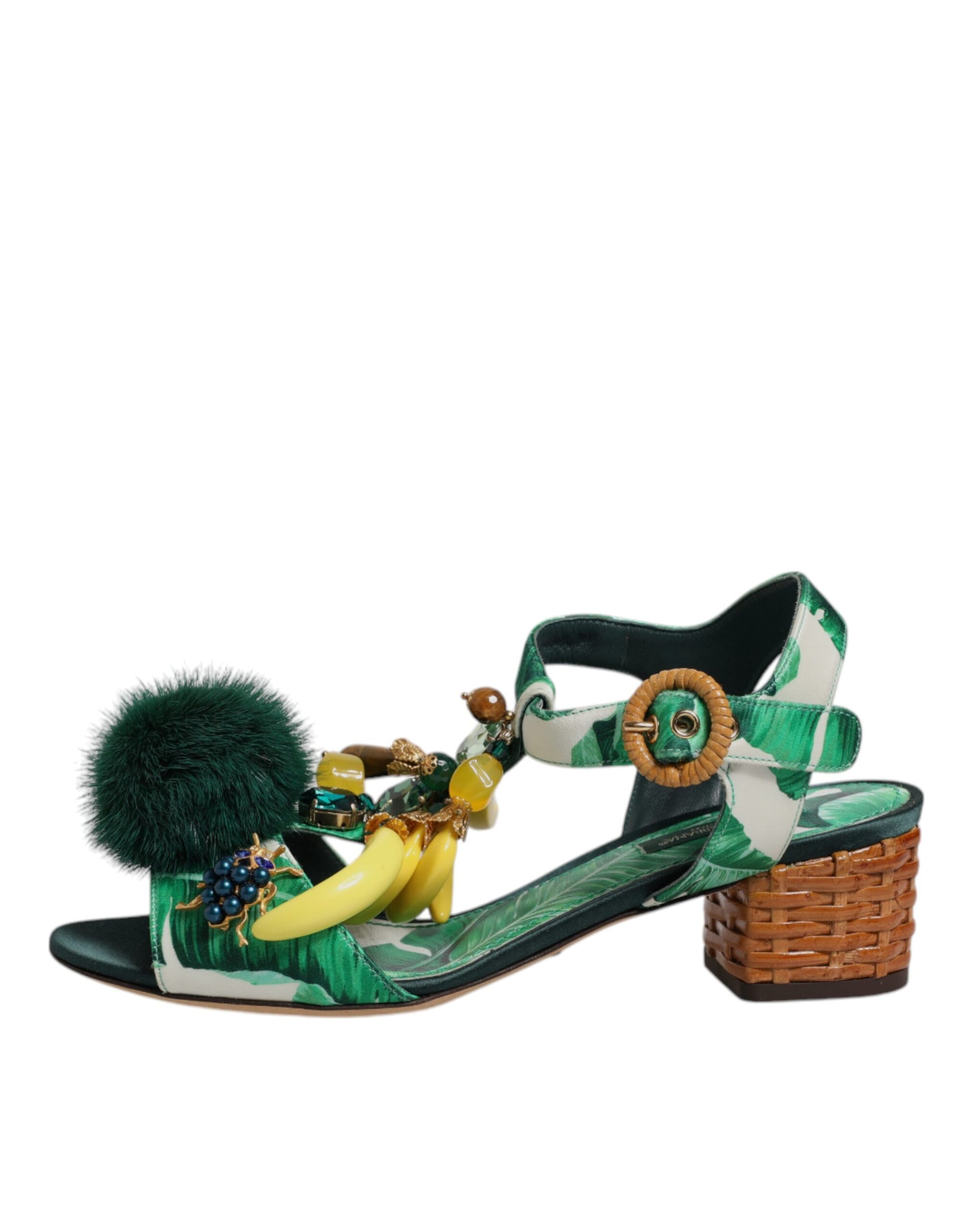 High heel sandal with tropical print, banana and strawberry embellishments, and a feathered pom pom on the ankle strap
