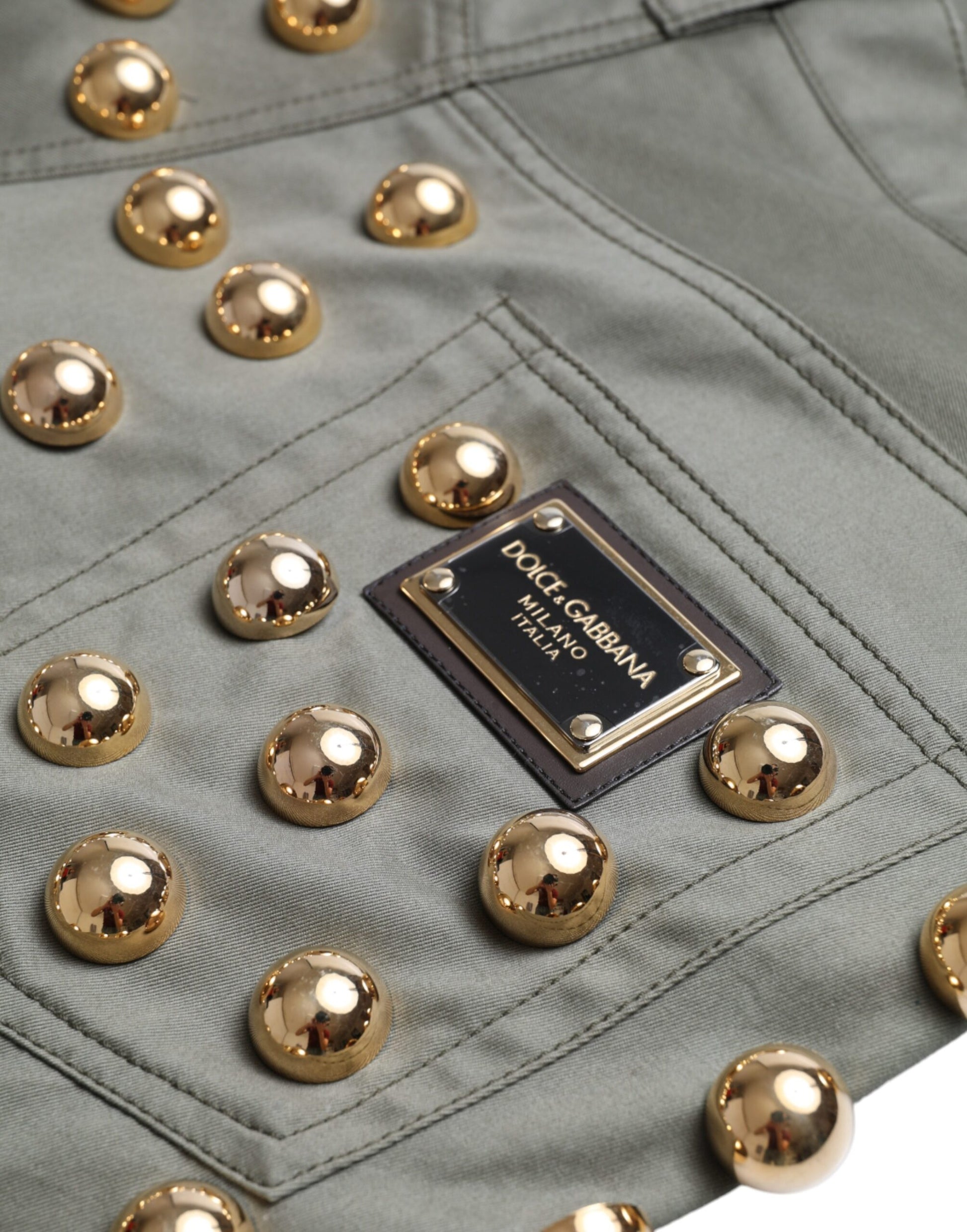 Green jacket with gold buttons and a label on the chest