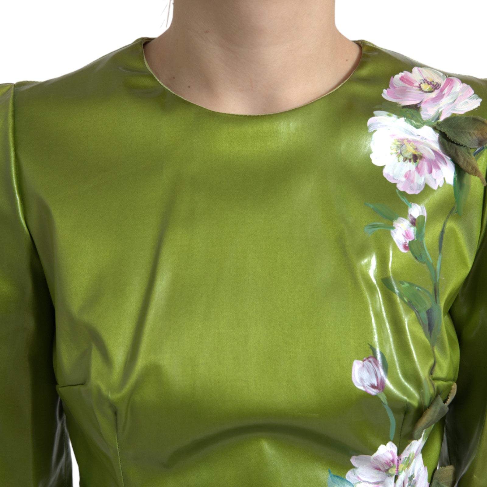 A green dress with floral embellishments on the bodice and sleeves