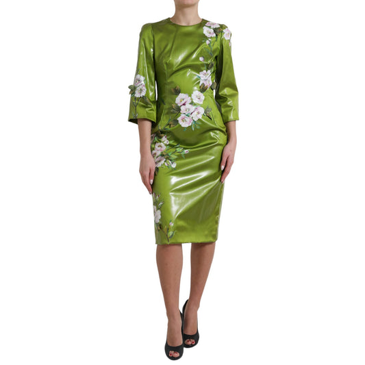 A green dress with floral embellishments and a sheath silhouette, midi length