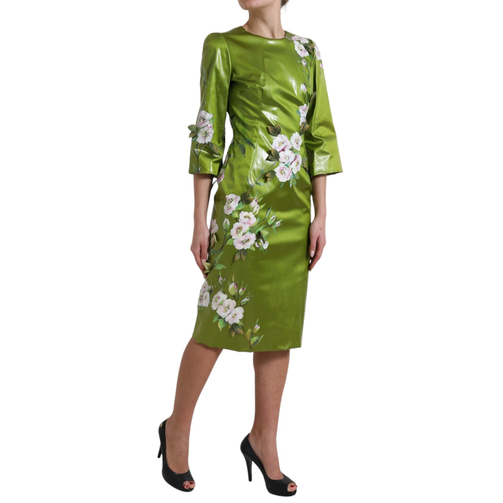 A green midi dress with floral embellishments and a sheath silhouette
