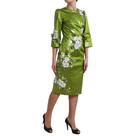 A green midi dress with floral embellishments and a sheath silhouette