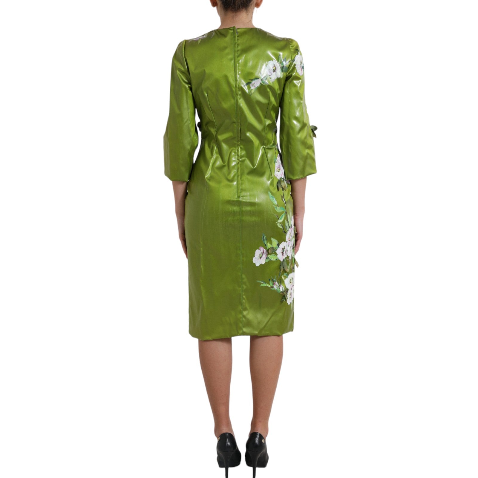 A green dress with floral embellishments on a mannequin