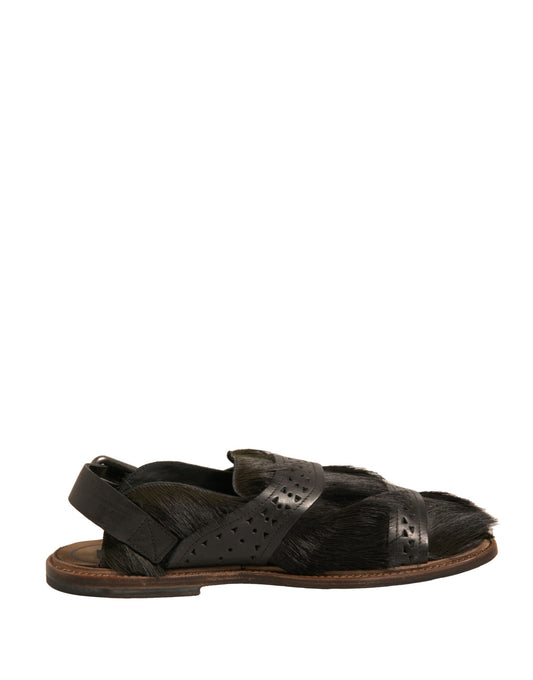 Pair of black sandals with brown soles