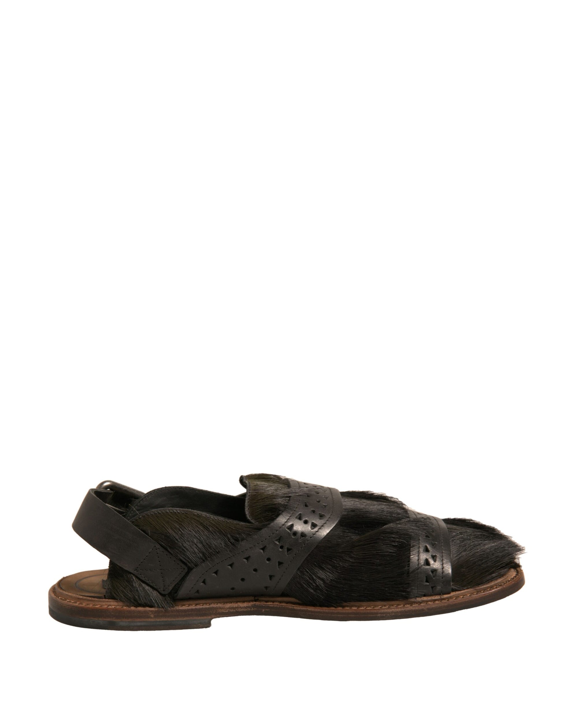Pair of black sandals with brown soles