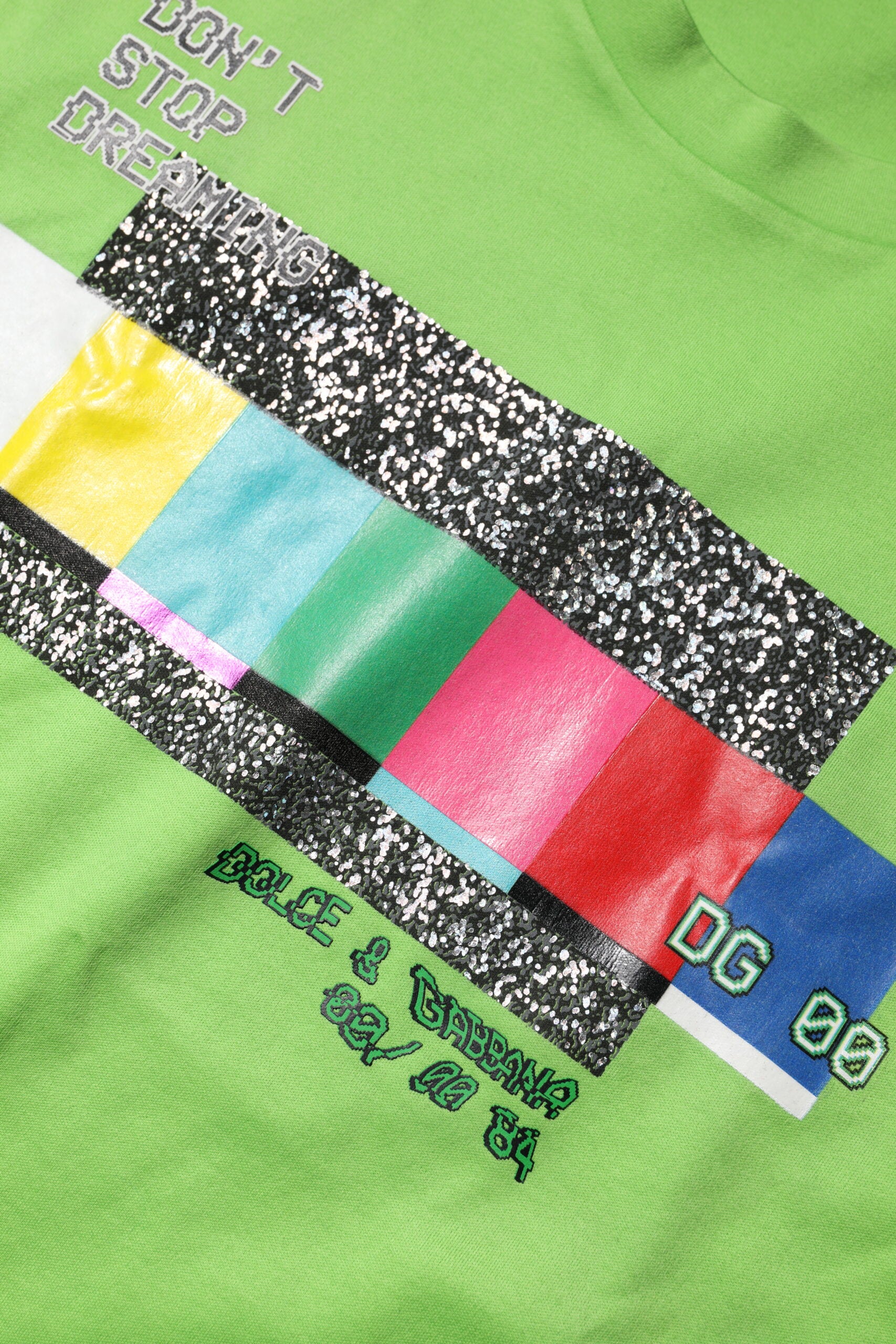 Green t-shirt with colorful stripe design