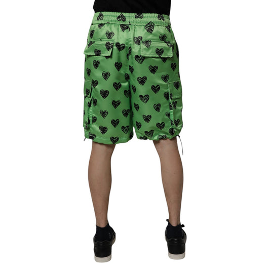 A pair of green men's shorts with a heart print design, featuring cargo pockets